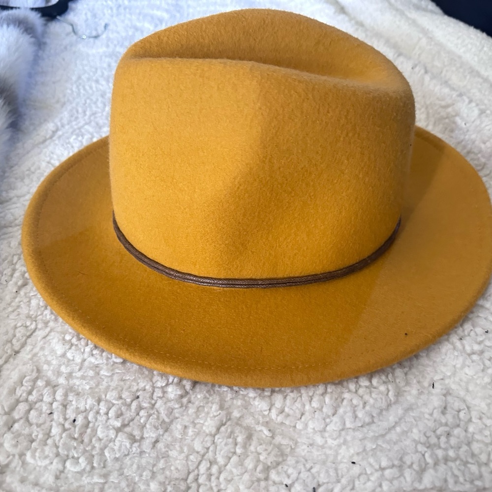 This is an amazing yellow orange hat that looks western with the the leather